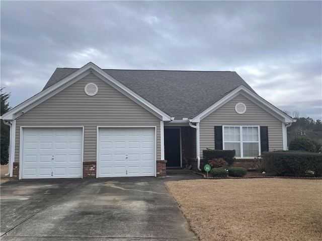 single story home with driveway, roof with shingles, a garage, and brick siding