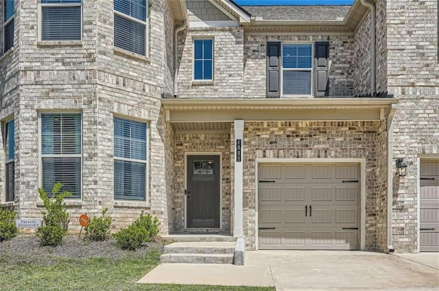 view of front facade featuring an attached garage, concrete driveway, and brick siding