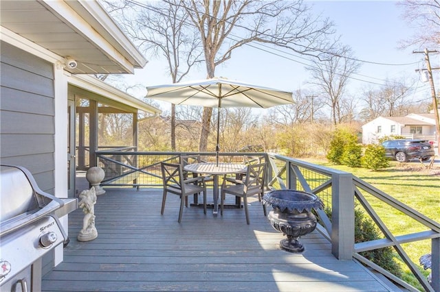 deck featuring a grill and outdoor dining area