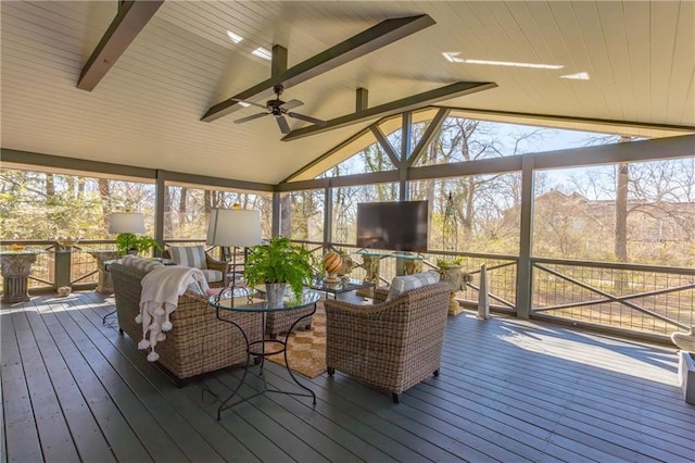 sunroom featuring vaulted ceiling with beams and a ceiling fan