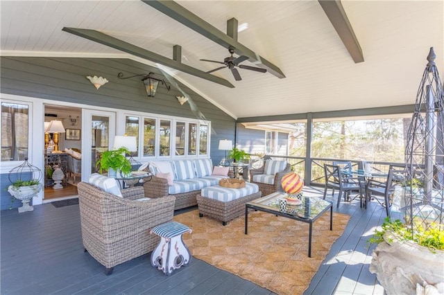 sunroom / solarium with vaulted ceiling with beams, a healthy amount of sunlight, and ceiling fan