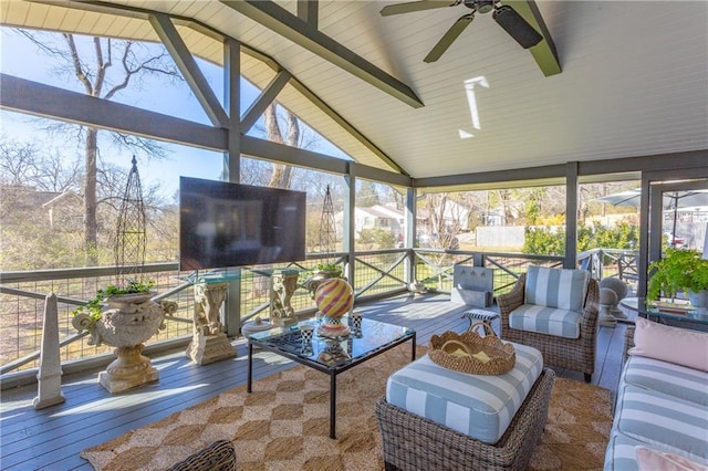 sunroom featuring lofted ceiling and a healthy amount of sunlight