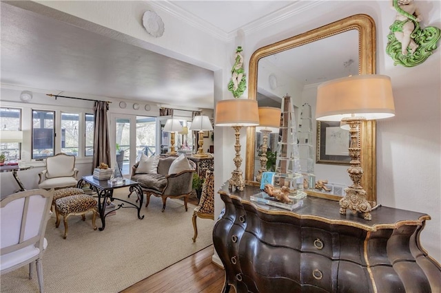 living area with wood finished floors and ornamental molding