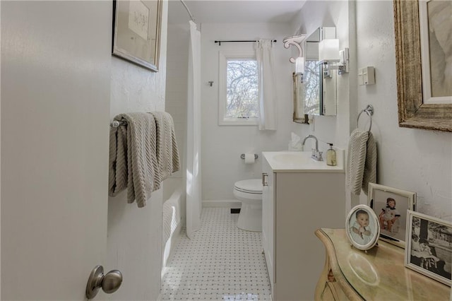 bathroom with vanity, baseboards, tile patterned floors, toilet, and shower / tub combo with curtain