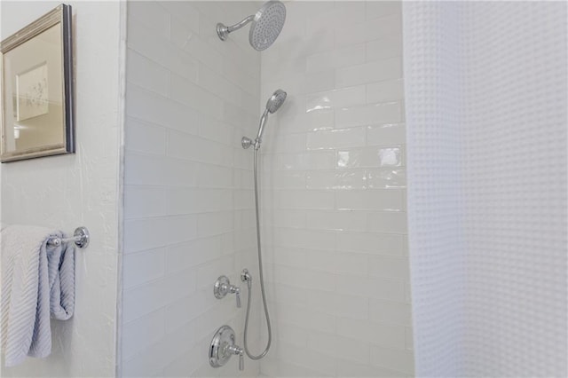 interior details featuring a tile shower