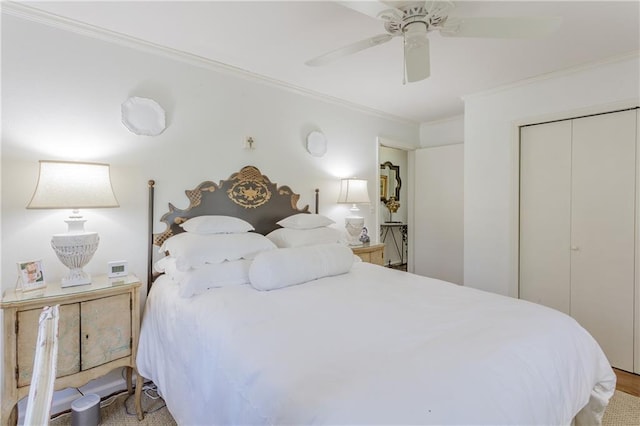 bedroom with a closet, ceiling fan, and ornamental molding