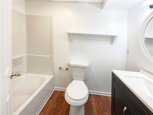 bathroom with hardwood / wood-style flooring, vanity, and toilet