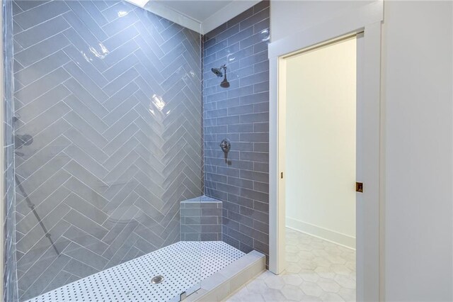 bathroom featuring a tile shower and tile patterned floors