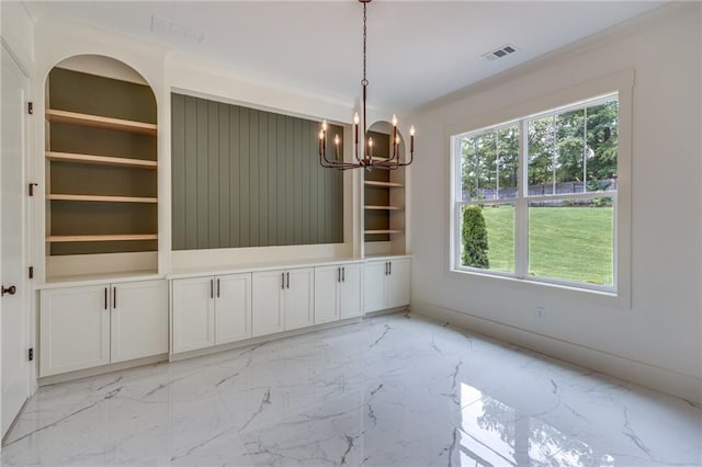 unfurnished dining area featuring a notable chandelier