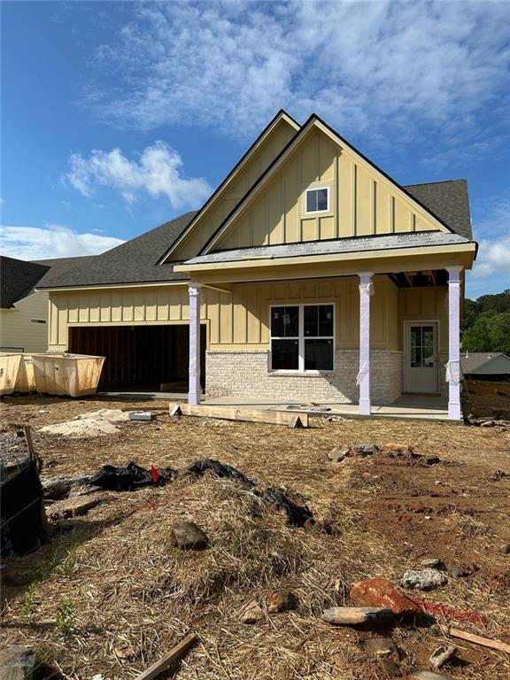 2004 Homestead Ct, Woodstock, GA 30189 - view of front of property with board and batten siding, roof with shingles, covered porch, and brick siding