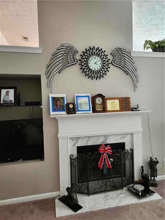 979 Simonton Glen Dr, Lawrenceville, GA 30045 - detailed view of a high end fireplace and carpet flooring