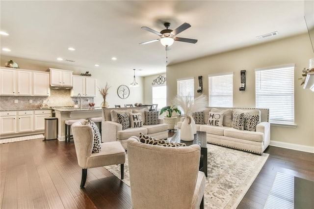 living room featuring visible vents, dark wood-type flooring, a ceiling fan, recessed lighting, and baseboards