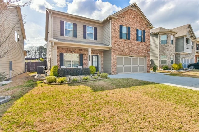 traditional-style home featuring driveway, a front lawn, a garage, and fence