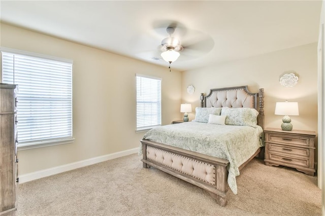 bedroom with visible vents, baseboards, ceiling fan, and carpet flooring