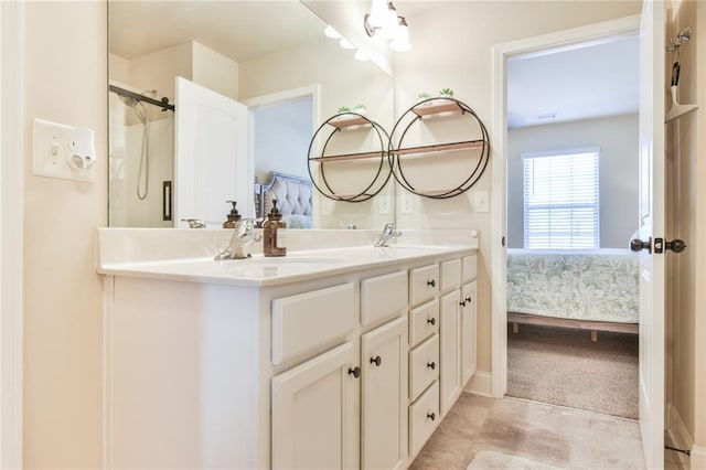 bathroom with a sink, walk in shower, double vanity, and ensuite bathroom