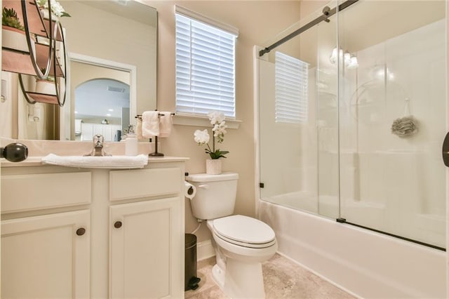 full bath with vanity, tile patterned floors, toilet, and enclosed tub / shower combo