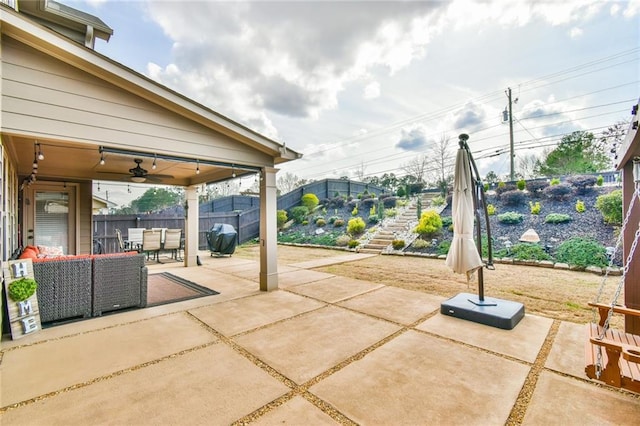 view of patio / terrace with area for grilling, ceiling fan, stairs, and fence