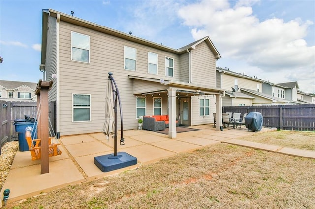 back of house featuring a fenced backyard and a patio area