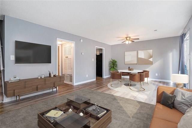 1151 Rankin St Unit 20A, Stone Mountain, GA 30083 - living room featuring wood finished floors, a ceiling fan, and a textured ceiling