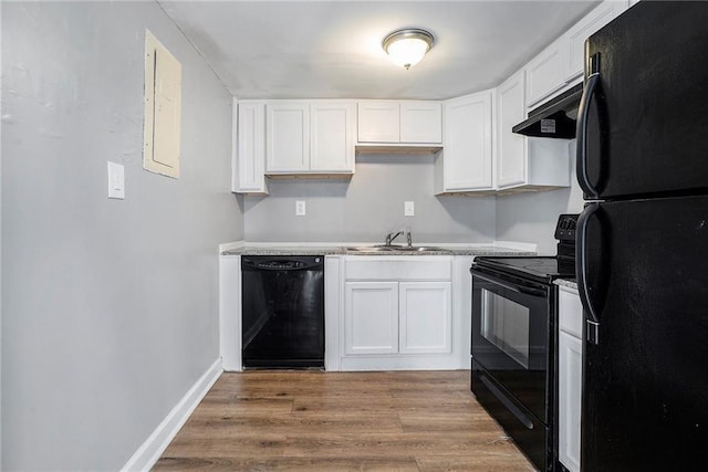 1151 Rankin St Unit 20A, Stone Mountain, GA 30083 - kitchen featuring black appliances, under cabinet range hood, white cabinetry, light countertops, and light wood-style floors