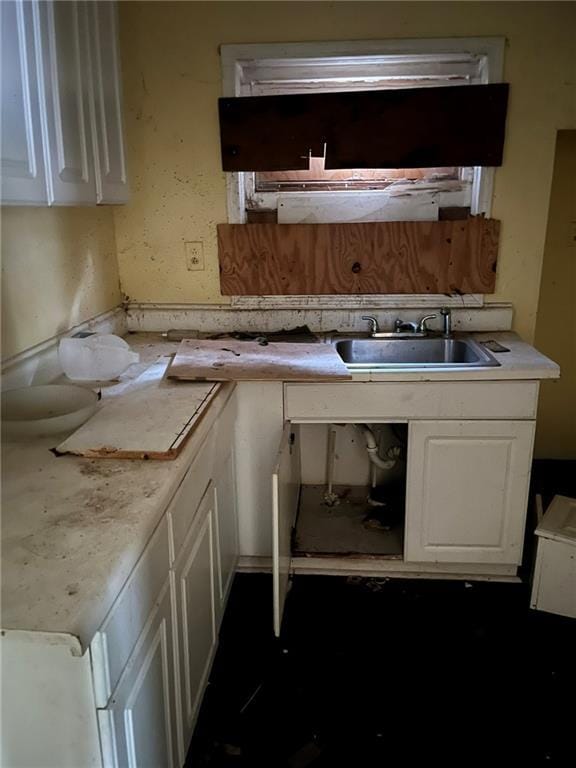 kitchen featuring white cabinets and sink