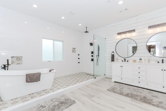 6044 Wade Orr Rd, Flowery Branch, GA 30542 - full bath with walk in shower, double vanity, a freestanding tub, and recessed lighting