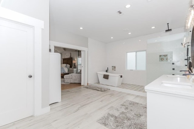 6044 Wade Orr Rd, Flowery Branch, GA 30542 - bathroom with walk in shower, a freestanding bath, ensuite bath, recessed lighting, and wood finished floors