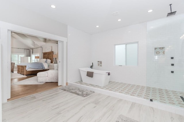 6044 Wade Orr Rd, Flowery Branch, GA 30542 - ensuite bathroom featuring a walk in shower, wood finished floors, a freestanding bath, and recessed lighting