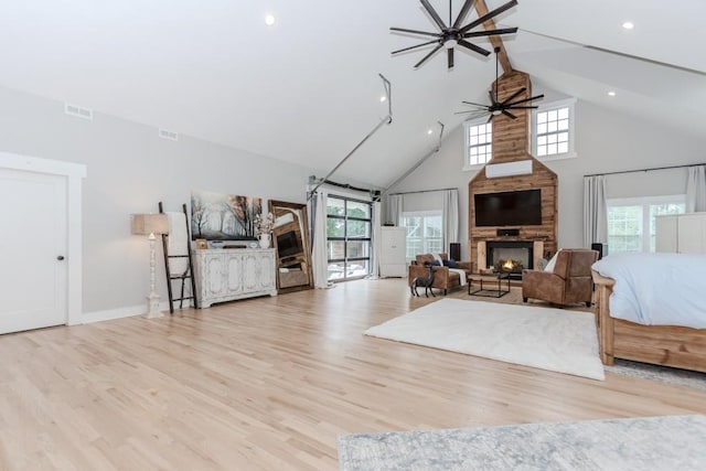6044 Wade Orr Rd, Flowery Branch, GA 30542 - living area with high vaulted ceiling, a large fireplace, ceiling fan, wood finished floors, and recessed lighting
