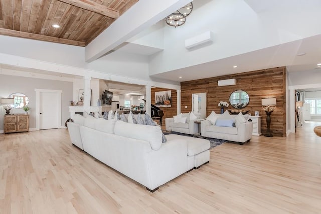 6044 Wade Orr Rd, Flowery Branch, GA 30542 - living area featuring a wall unit AC, light wood-style floors, a wood ceiling with exposed beams, a wall mounted air conditioner, and a towering ceiling