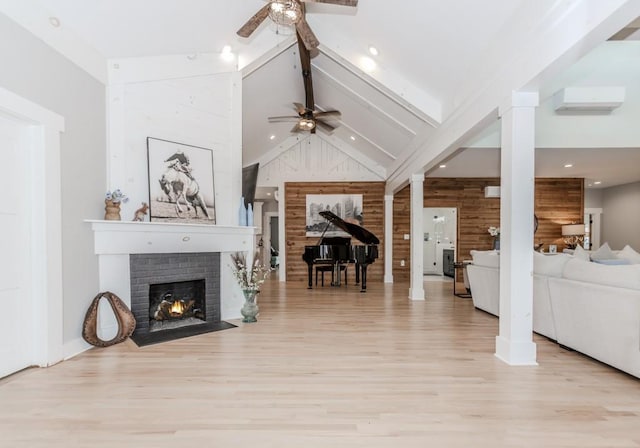 6044 Wade Orr Rd, Flowery Branch, GA 30542 - living room featuring a ceiling fan, wood walls, beamed ceiling, a fireplace, and wood finished floors