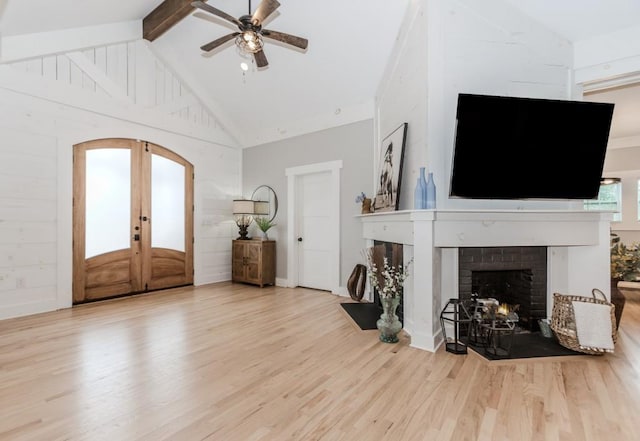 6044 Wade Orr Rd, Flowery Branch, GA 30542 - foyer with a fireplace, wood finished floors, ceiling fan, arched walkways, and beam ceiling