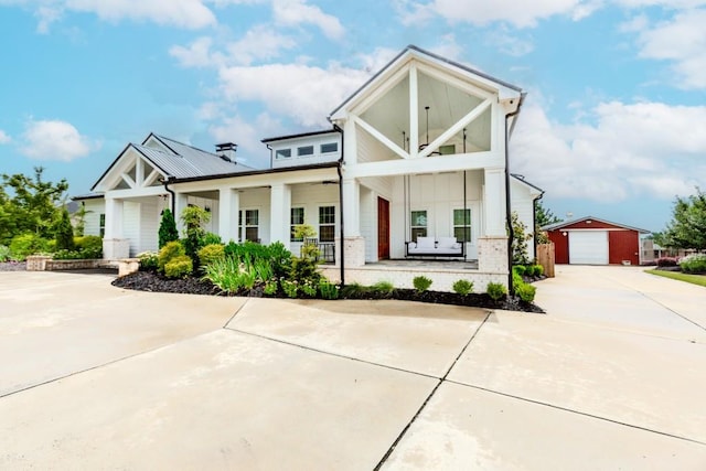 6044 Wade Orr Rd, Flowery Branch, GA 30542 - modern inspired farmhouse with an outdoor structure, covered porch, driveway, a garage, and board and batten siding