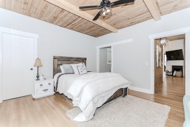 6044 Wade Orr Rd, Flowery Branch, GA 30542 - bedroom featuring a wooden ceiling with exposed beams, light wood-style floors, a fireplace, and ceiling fan