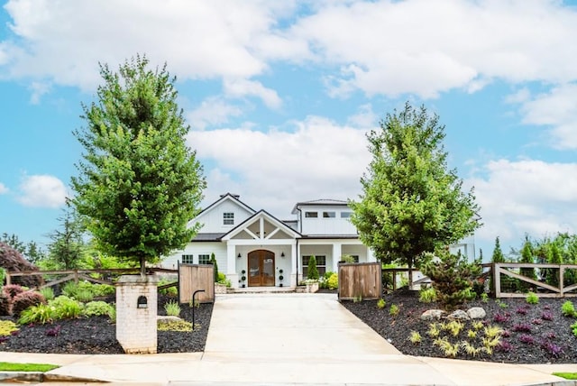 6044 Wade Orr Rd, Flowery Branch, GA 30542 - craftsman inspired home with a fenced front yard, concrete driveway, and a porch