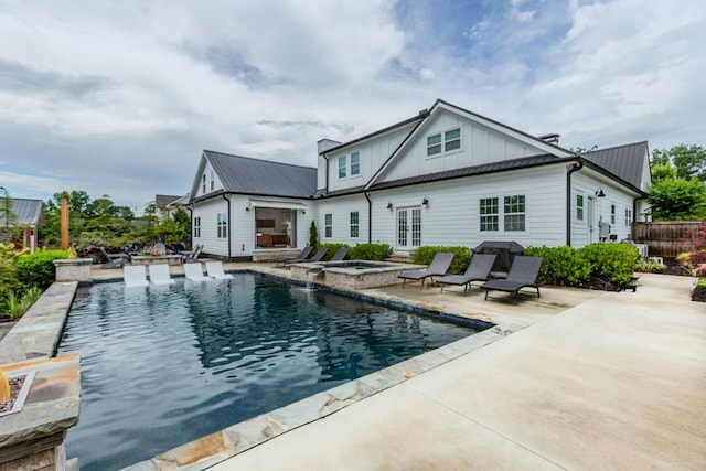 6044 Wade Orr Rd, Flowery Branch, GA 30542 - rear view of house featuring a patio area, board and batten siding, a metal roof, a pool with connected hot tub, and french doors