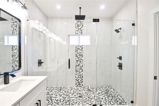 full bath with recessed lighting, vanity, and a marble finish shower