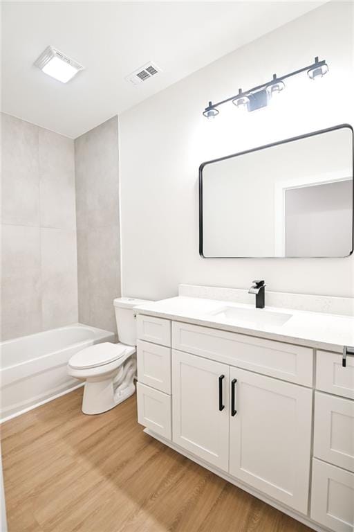 full bathroom featuring visible vents, vanity, toilet, and wood finished floors