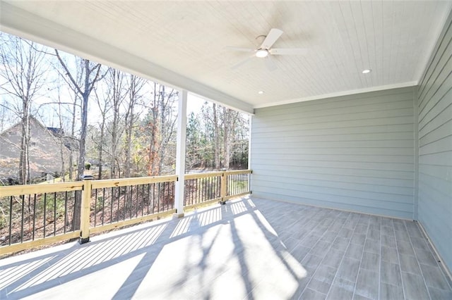 unfurnished sunroom featuring wood ceiling and ceiling fan