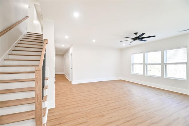 unfurnished living room featuring recessed lighting, visible vents, baseboards, stairs, and light wood-style floors