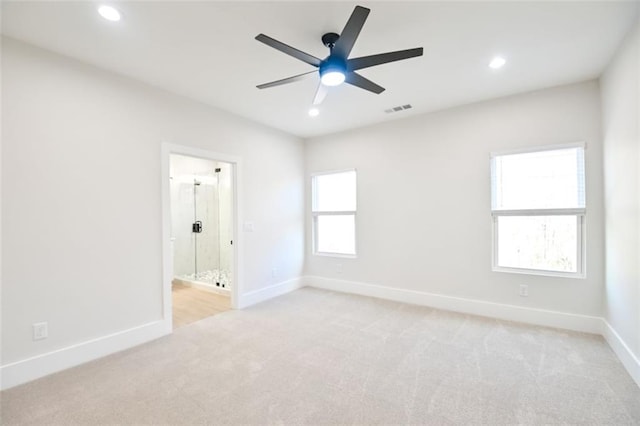 spare room featuring light carpet, baseboards, visible vents, and recessed lighting