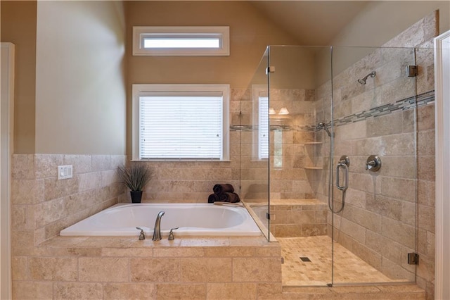 full bathroom with lofted ceiling, a bath, and a stall shower