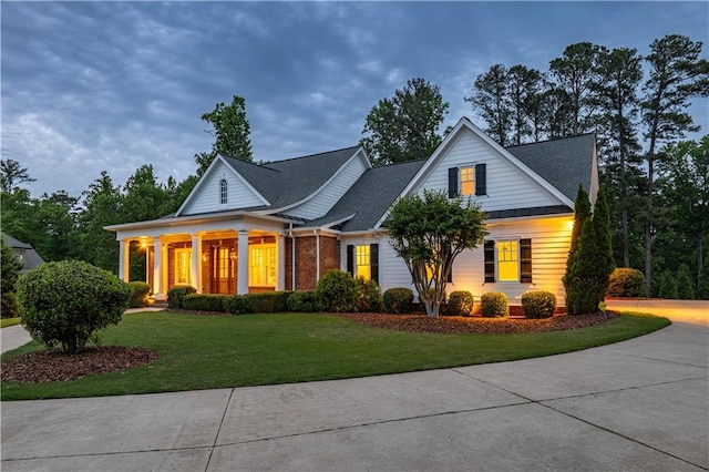 view of front of home with brick siding and a front yard