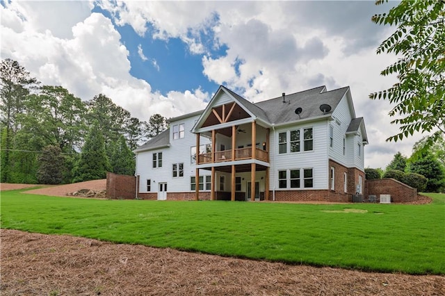 back of house with brick siding, central AC unit, ceiling fan, and a lawn