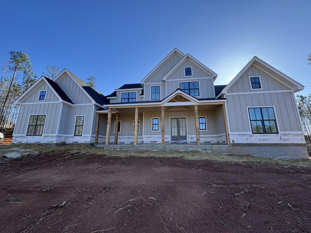 modern farmhouse featuring a porch and board and batten siding