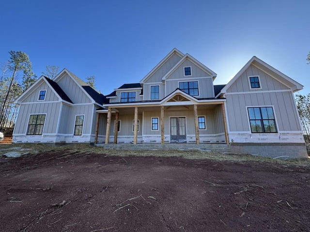 modern farmhouse featuring a porch and board and batten siding