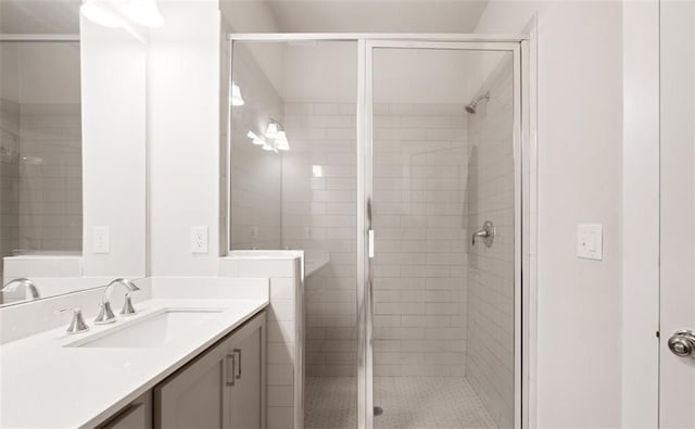 bathroom featuring vanity and an enclosed shower