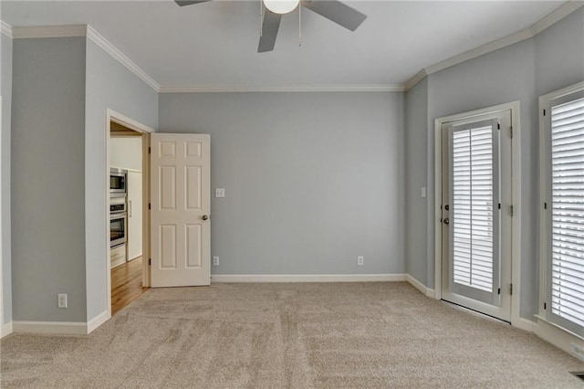 interior space with a tray ceiling, baseboards, and ceiling fan