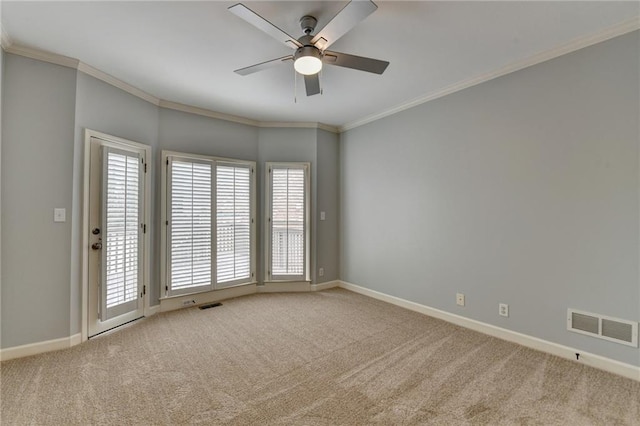 kitchen with a raised ceiling, stainless steel microwave, crown molding, and baseboards