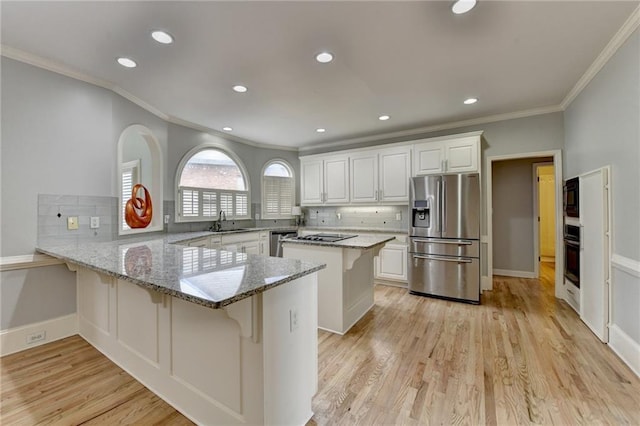 kitchen with crown molding, ceiling fan, baseboards, a tray ceiling, and light tile patterned flooring